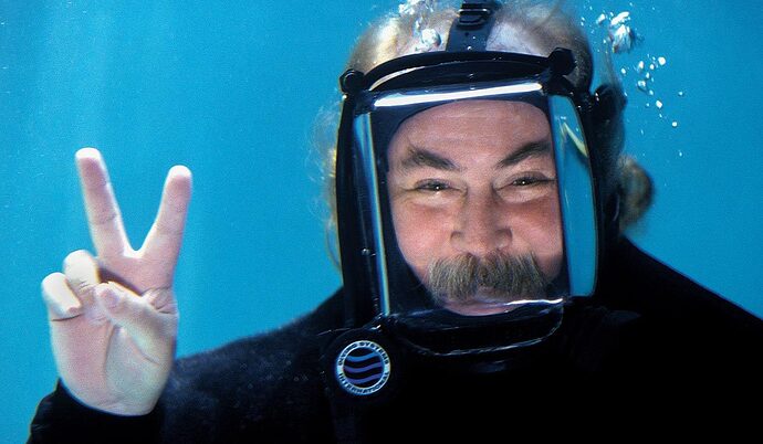 man-in-scuba-mask-and-has-a-mustache-is-giving-the-peace-sign